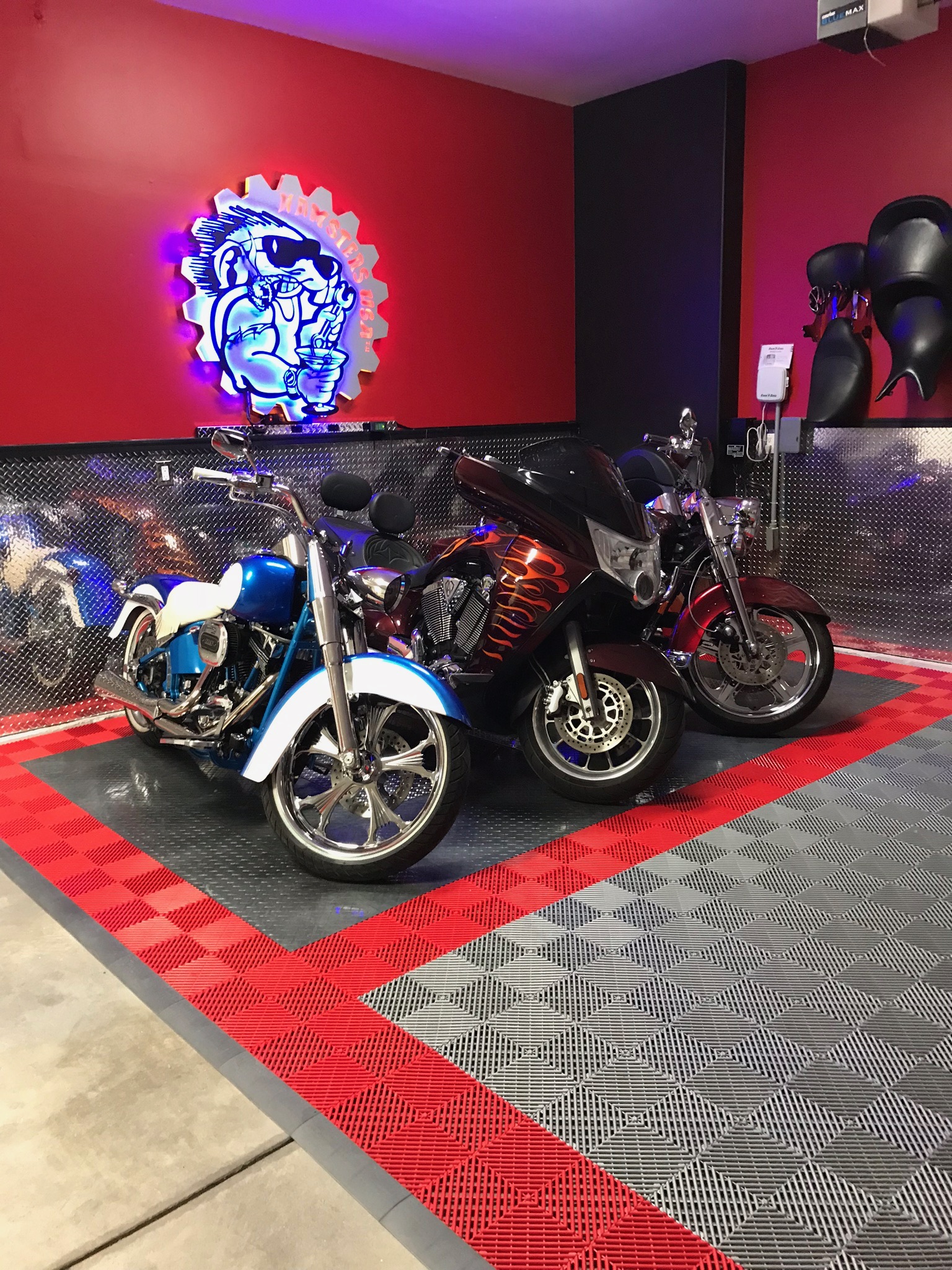 Motorcycle garage with neon sign and diamond-plate walls
