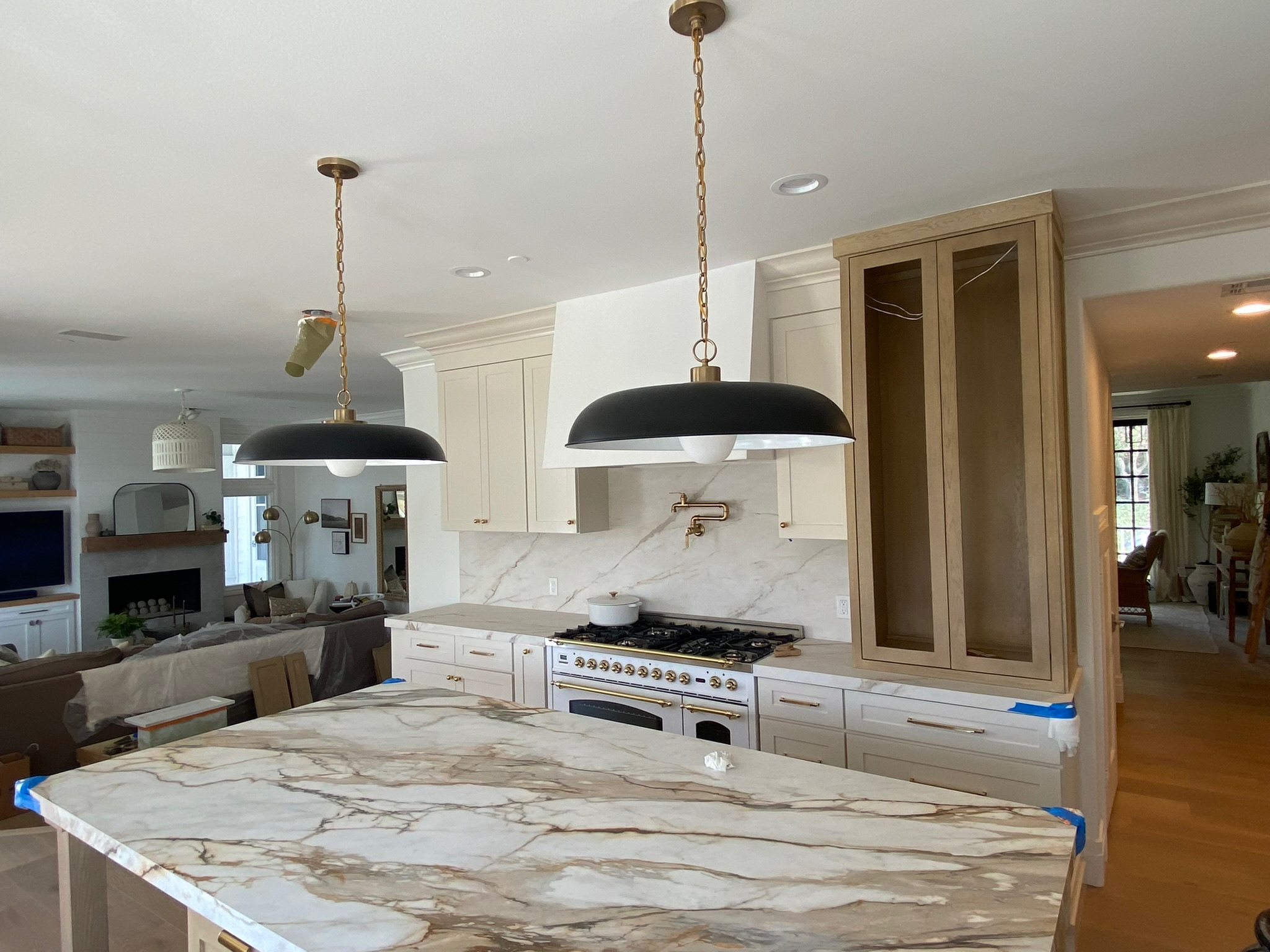Kitchen with navy tile backsplash and marble island