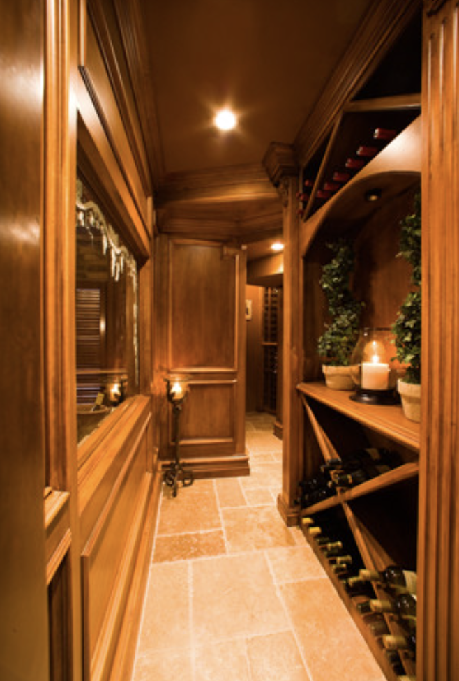Paneled wine cellar passage with candle