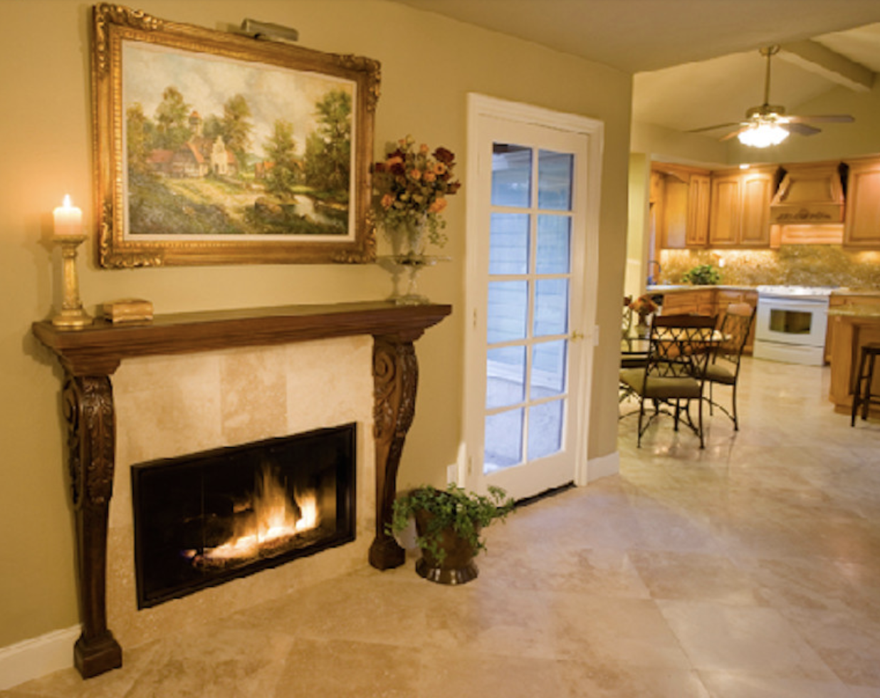Carved mantel with travertine fireplace