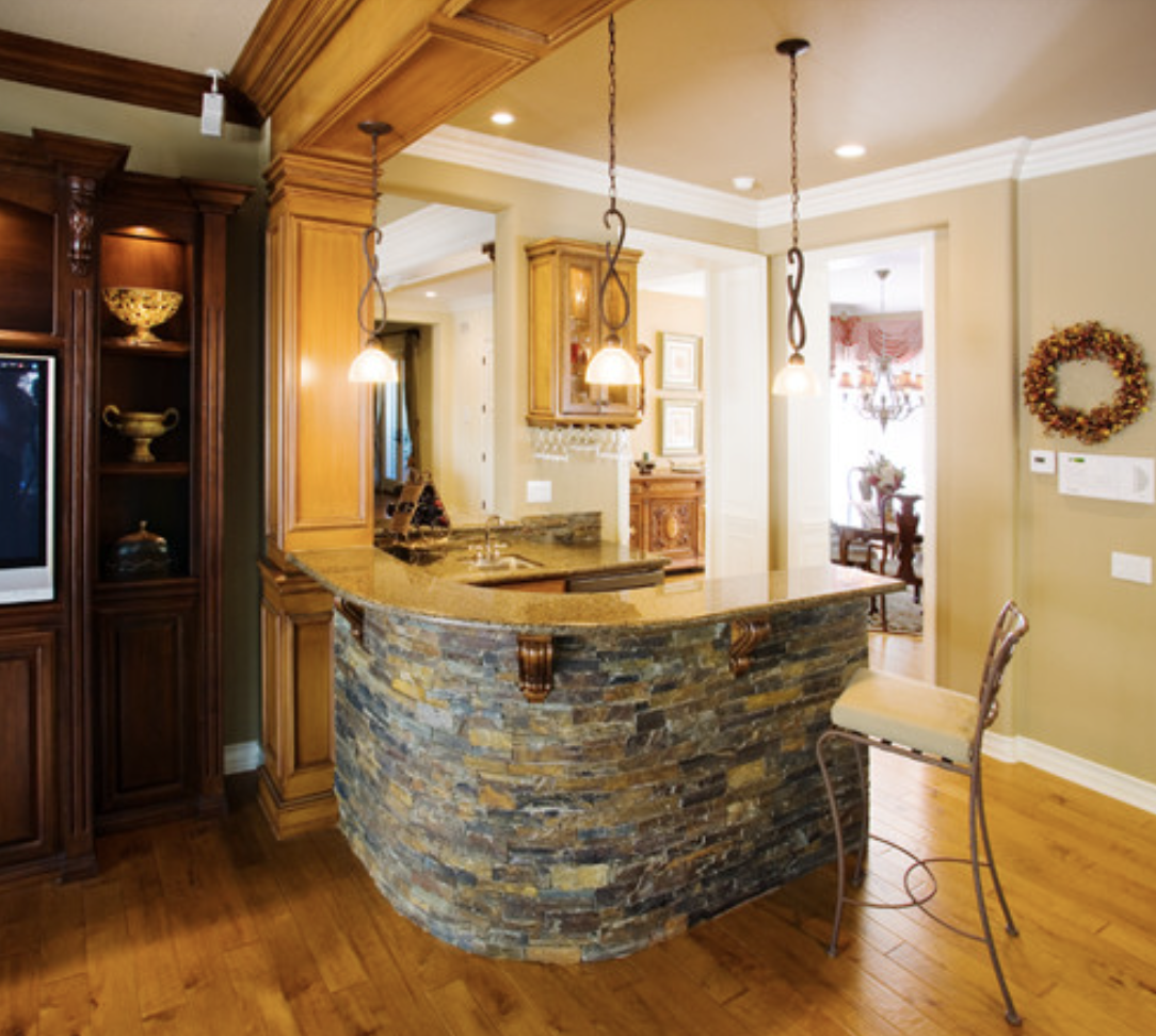 Stone bar with built-in media wall and bar seating