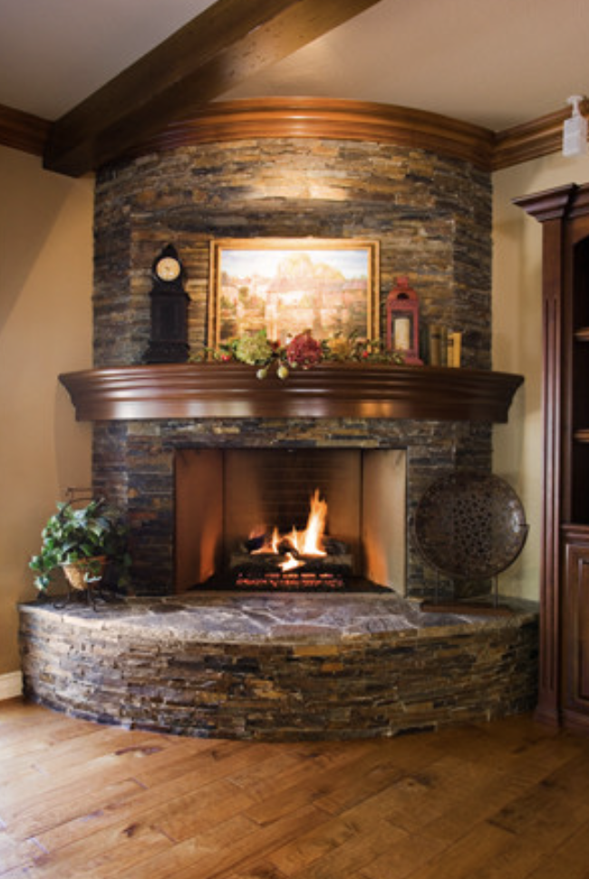 Corner fireplace with curved wood mantel