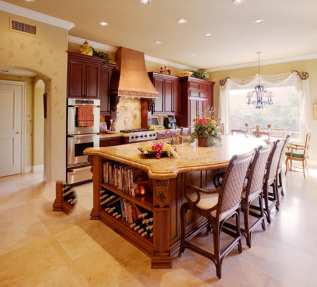White island kitchen with coffered ceiling and chandelier