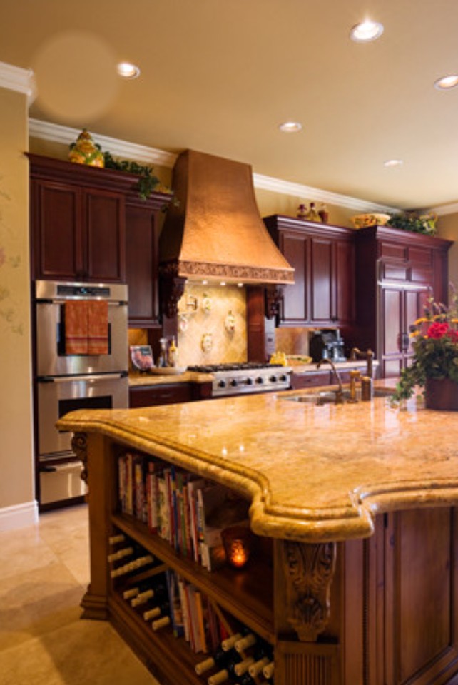 Granite island with bar seating and copper hood